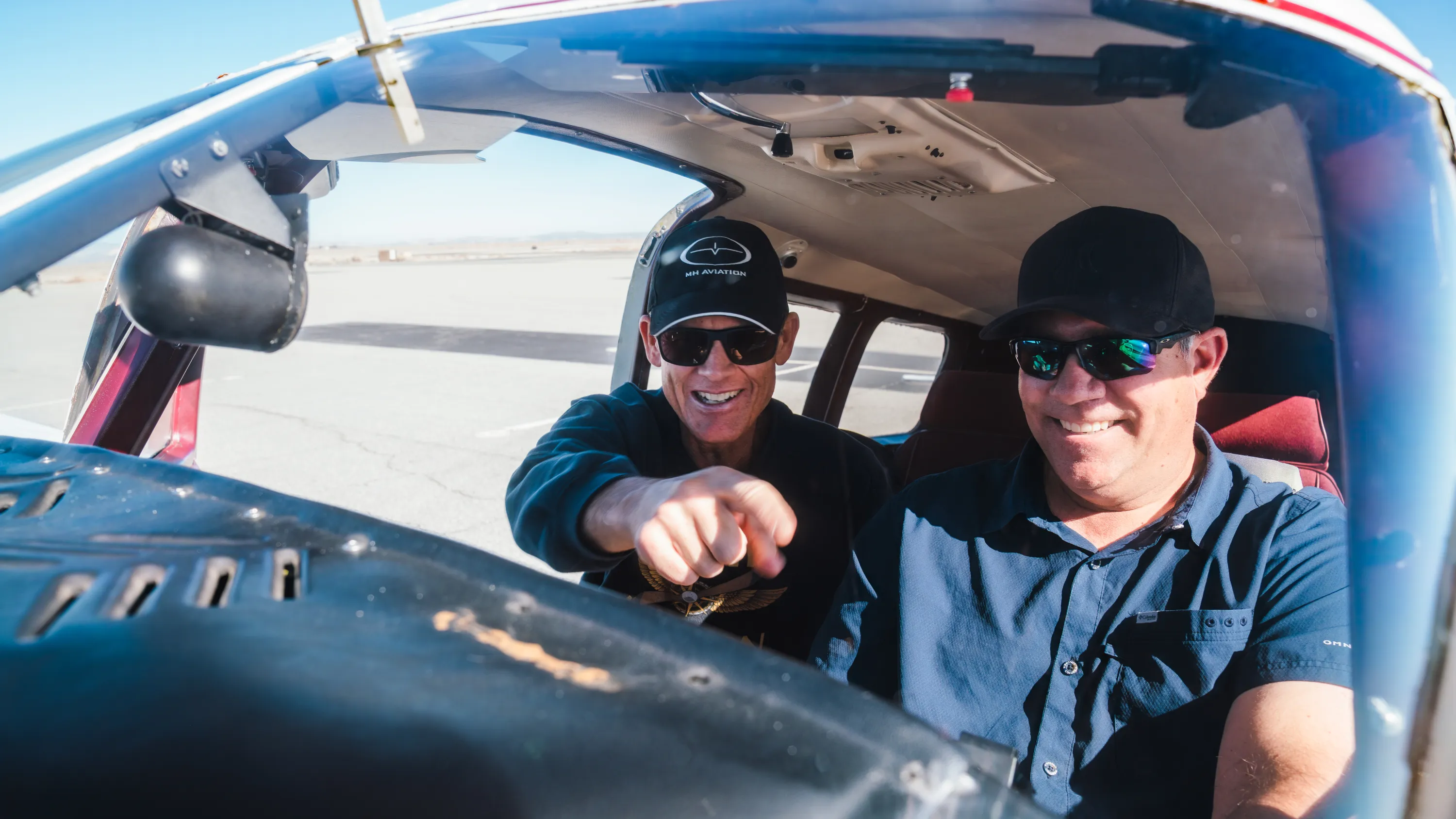 Student pilot and instructor in a cockpit at MH Aviation in Lancaster, CA