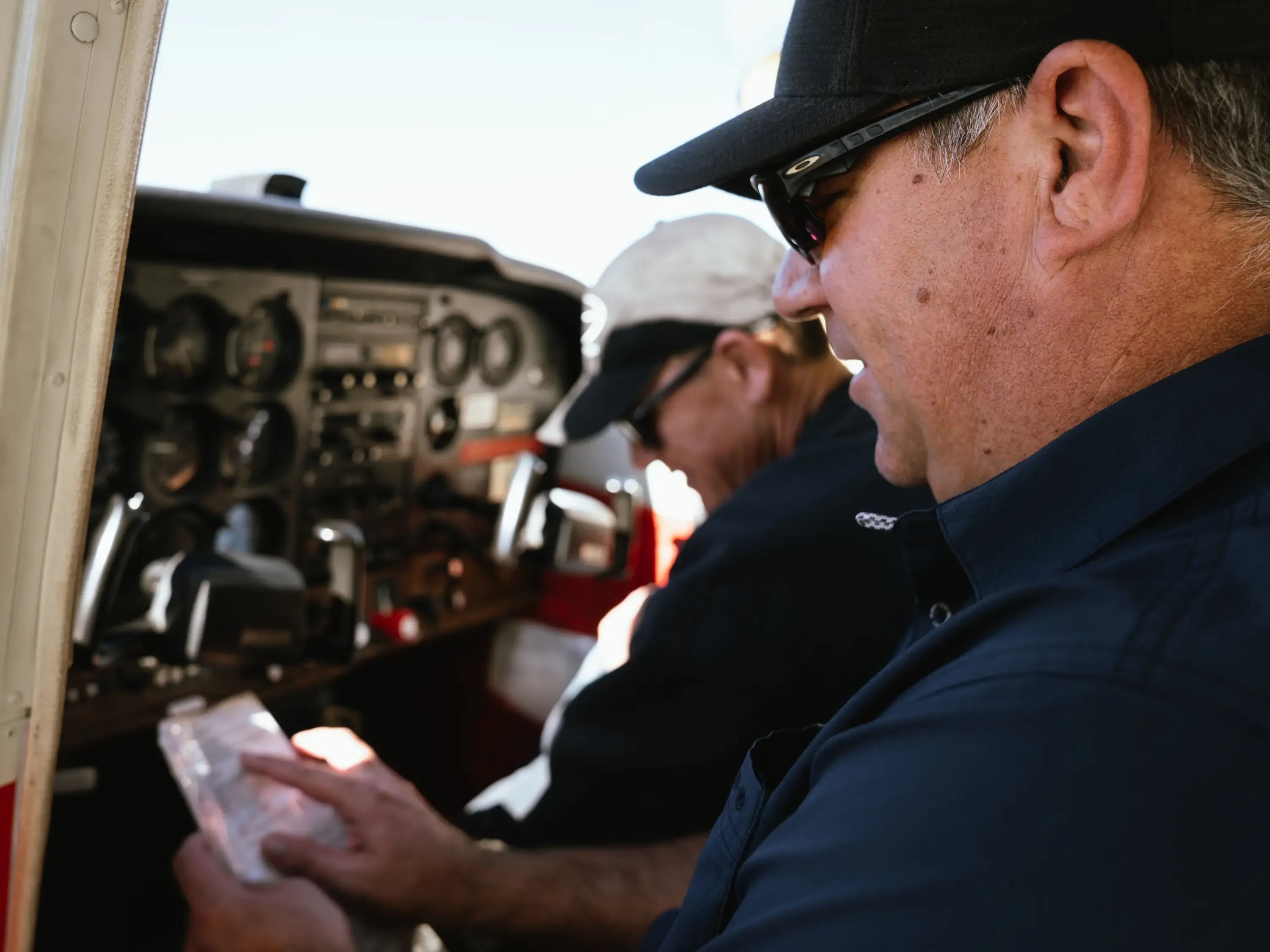 Pilot reviewing a preflight checklist with an MH Aviation instructor