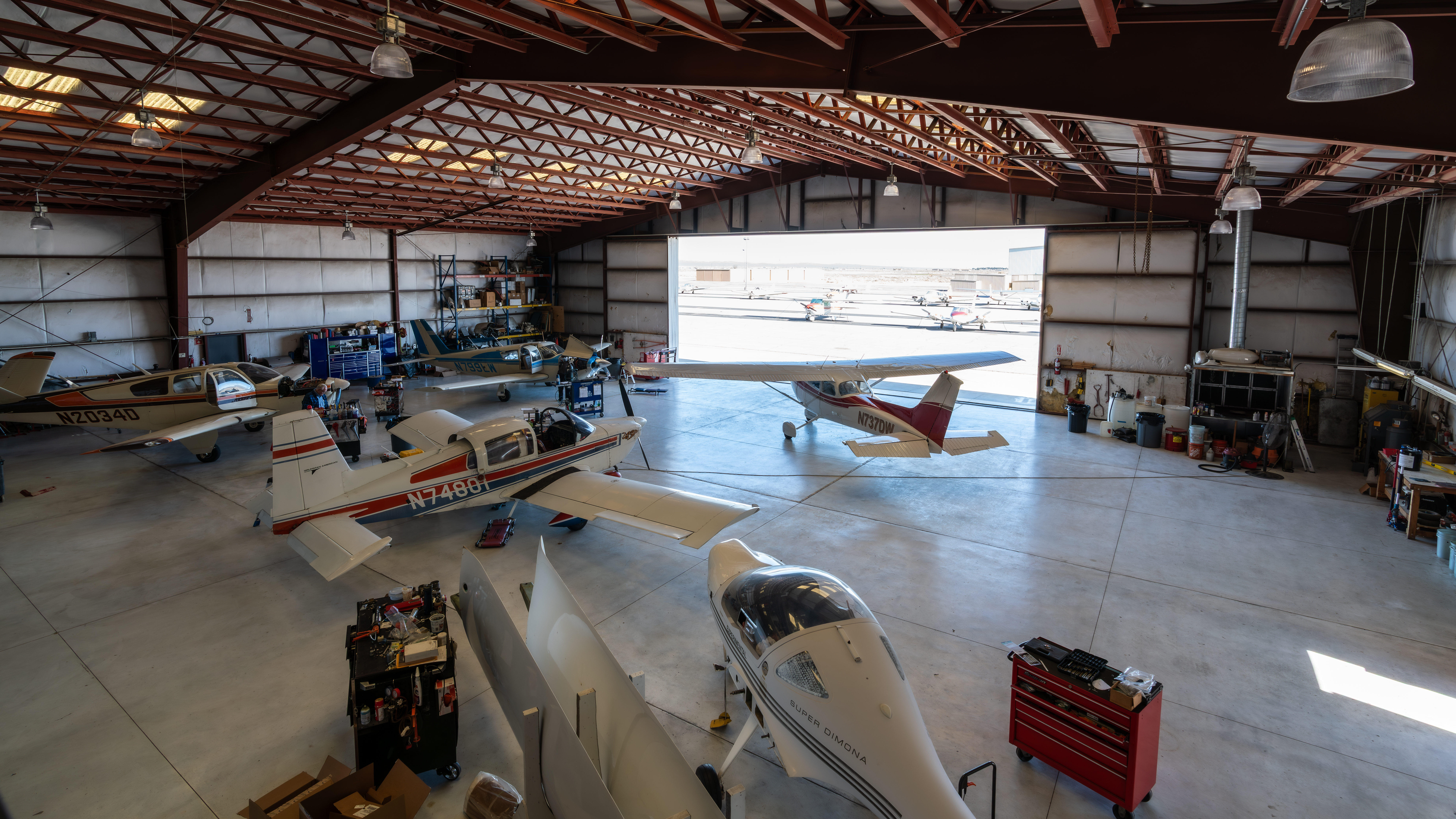 Certified aircraft mechanics servicing general aviation aircraft inside our Part 145 Repair Station hangar